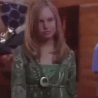 Woman in Green Dress Holding Purple Object