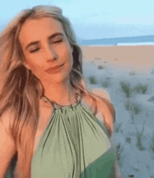 Woman in Green Dress on Beach