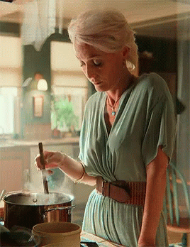 Woman In Green Dress Stirring Pot GIF