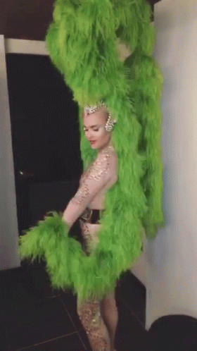 Woman In Green Feathered Costume GIF