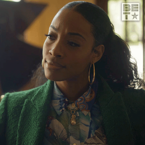 Woman in Green Jacket and Hoop Earrings Saying Sure