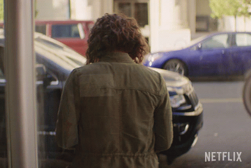 Woman in Green Jacket at Netflix Logo