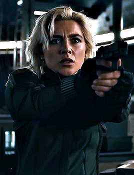 Woman in Green Jacket Hand to Ear Funny Face