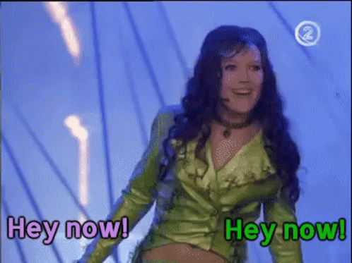 Woman In Green Jacket Says Hey Now GIF