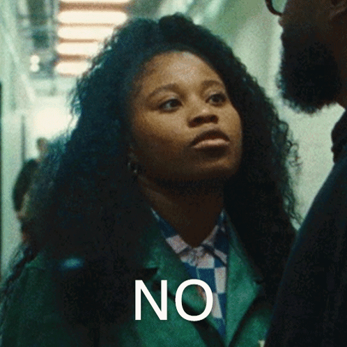 Woman In Green Jacket Standing Next To Man Saying No GIF