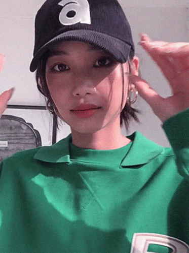 Woman in Green Shirt and Hat with Letter A