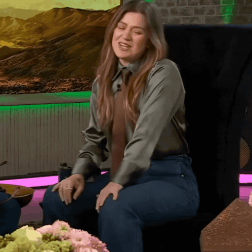 Woman In Green Shirt And Tie Sitting GIF