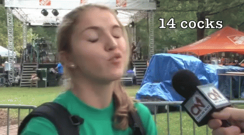 Woman in Green Shirt Blowing Kiss at Channel 8 Microphone