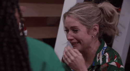 Woman In Green Shirt Crying Man Holding Hand GIF