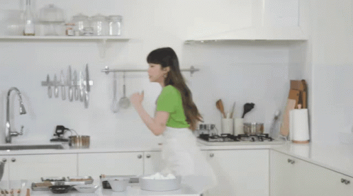 Woman in Green Shirt in Kitchen