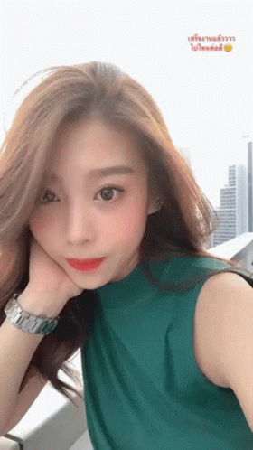 Woman In Green Shirt Taking Selfie GIF