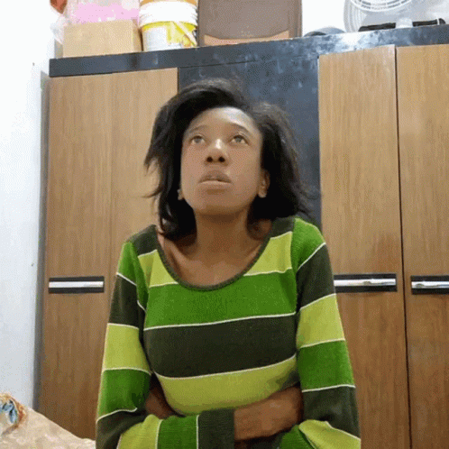 Woman In Green Striped Shirt Looking Up GIF