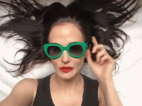 Woman in Green Sunglasses and Red Lips Lying