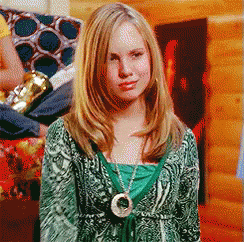 Woman in Green Sweater and Circle Necklace