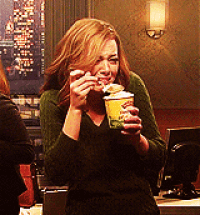 Woman in Green Sweater Holding Cup of Food