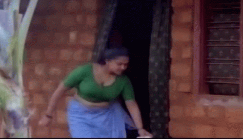 Woman in Green Top and Blue Skirt