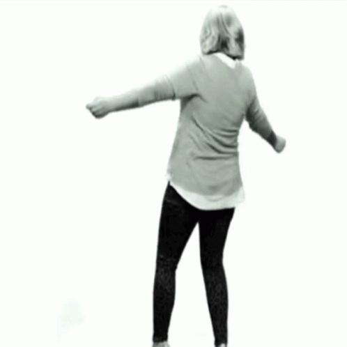 Woman In Grey And Black Dancing Arms Outstretched GIF