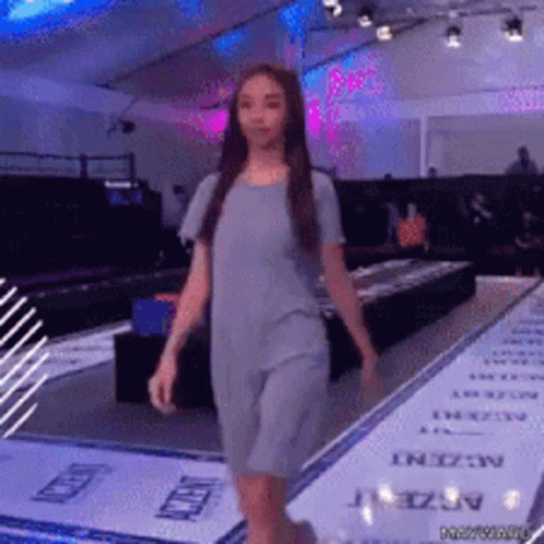 Woman in Grey Dress Walking Runway