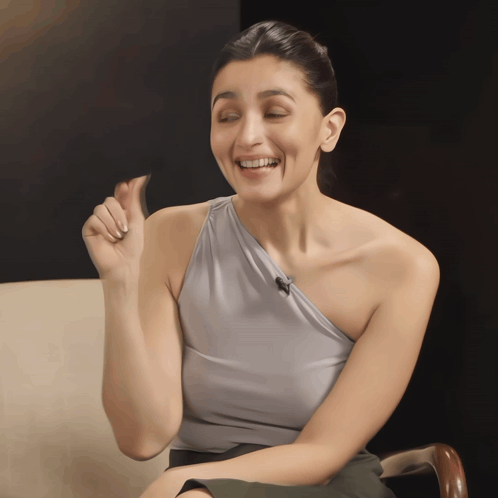Woman in Grey One-Shoulder Top Making Funny Face