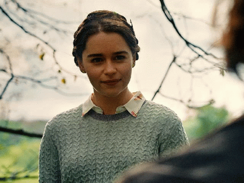 Woman in Grey Sweater and White Collar Looking at Camera
