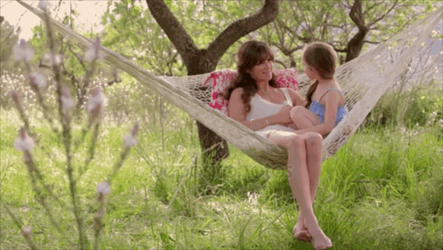 Woman In Hammock Holding Little Girl GIF