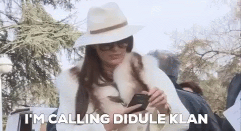 Woman In Hat And Fur Coat Calling Didule Klan GIF