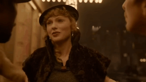 Woman in Hat and Fur Coat Talking to Man