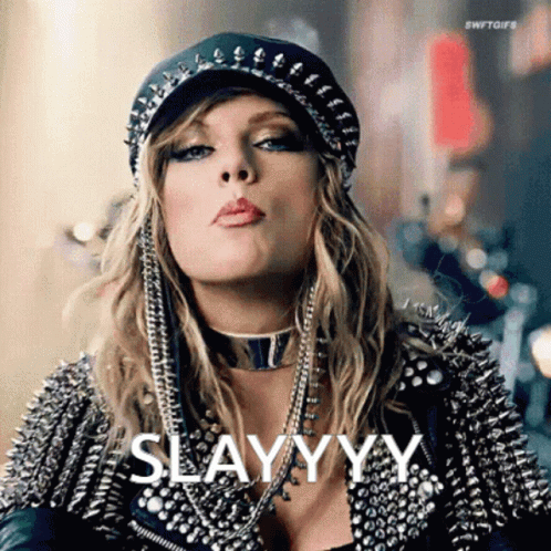 Woman in Hat and Leather Jacket Blowing a Kiss Saying Slayyyy