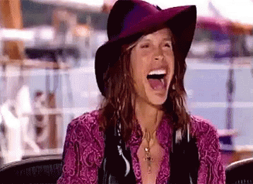 Woman In Hat And Purple Shirt Laughing GIF