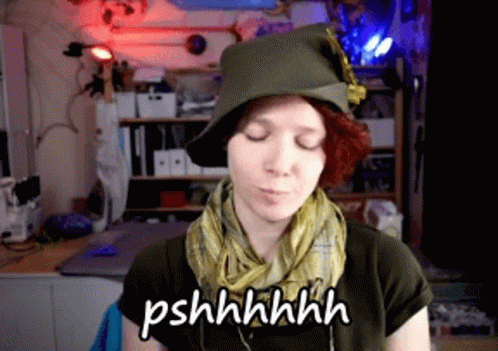 Woman in Hat and Scarf Says Pshhhhhh