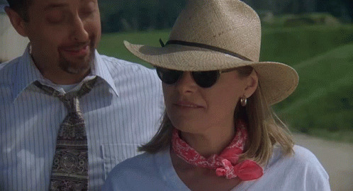 Woman In Hat And Sunglasses Next To Man GIF