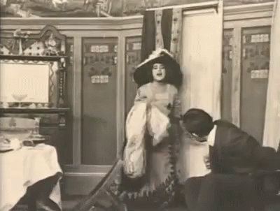 Woman in Hat Beside Man Black and White