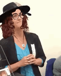 Woman In Hat Glasses And Blue Shirt Sitting GIF