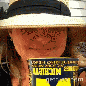 Woman in Hat Holding Can of Michigan