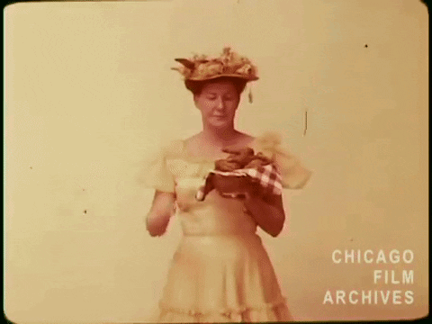 Woman in Hat Holding Dog