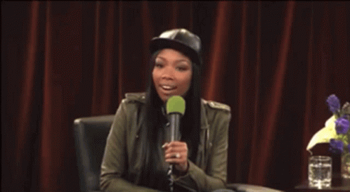 Woman In Hat Holding Microphone GIF