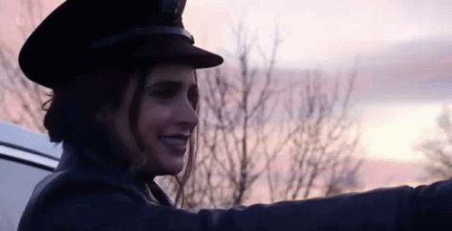 Woman in Hat Smiling in Back of Car