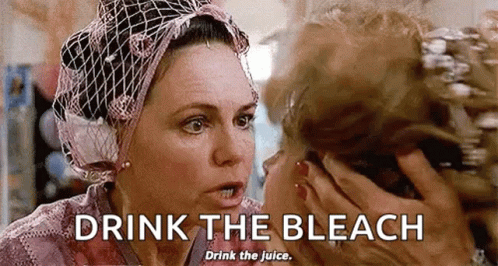 Woman in Head Scarf Talking and Drinking Bleach