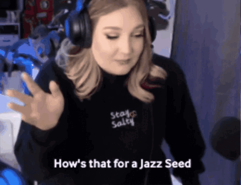 Woman in Headphones and Black Sweatshirt Saying Stay Salty