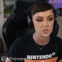 Woman in Headphones and Nintendo 64 Shirt Sitting in Chair