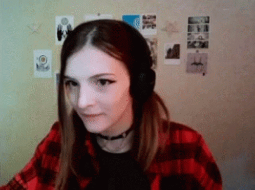 Woman in Headphones and Plaid Shirt Sitting by Wall