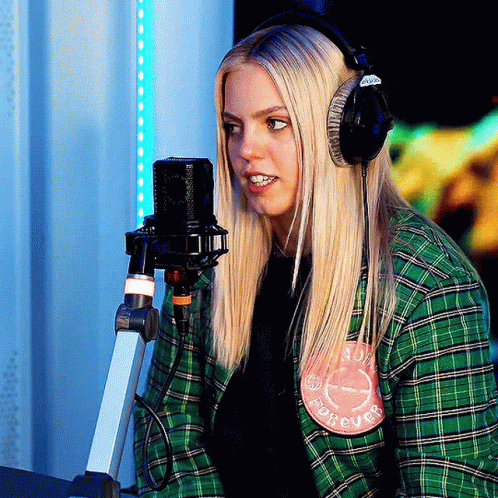 Woman in Headphones at Microphone With Forever Patch