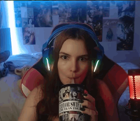 Woman In Headphones Drinking From Taylor Swift Cup GIF