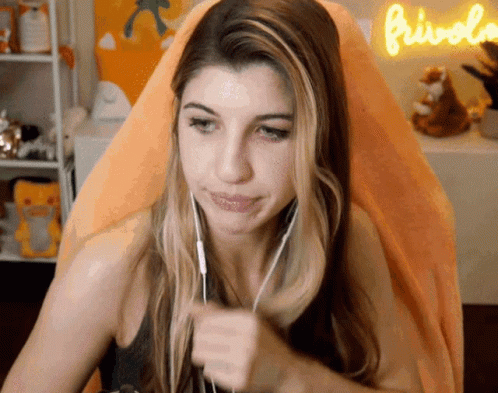 Woman in Headphones in Front of Orange Sign Frivolo