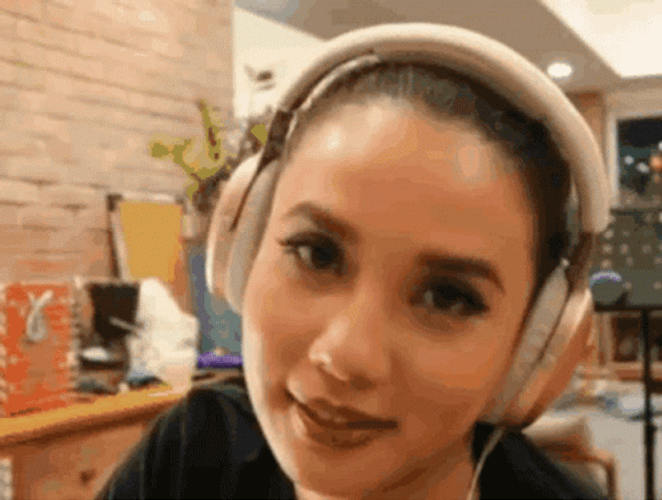 Woman In Headphones Rolls Her Eyes GIF