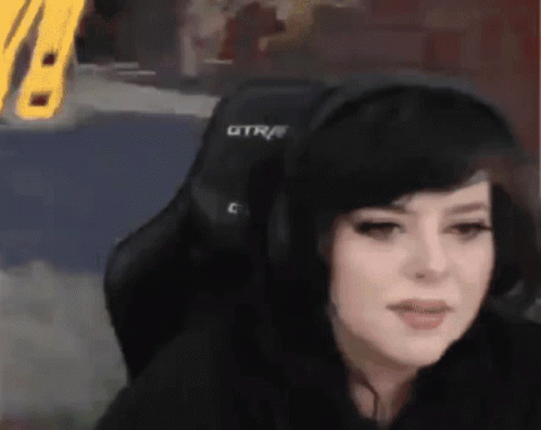 Woman in Headphones Sitting in Chair With GTR
