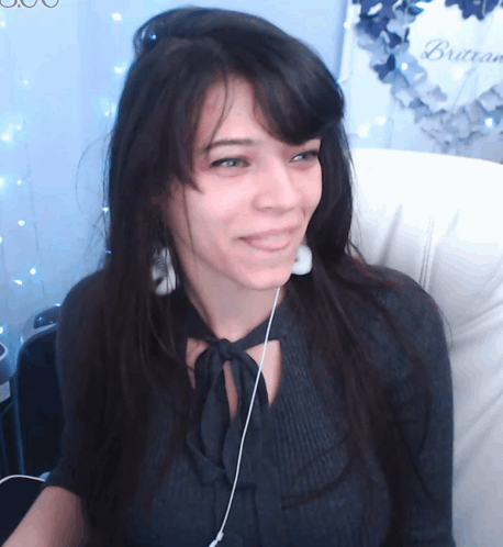 Woman In Headphones Smiling By Brasserie Wreath GIF