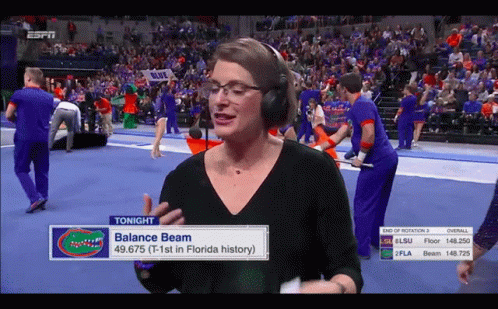 Woman in Headphones Talks About Balance Beam in Florida History