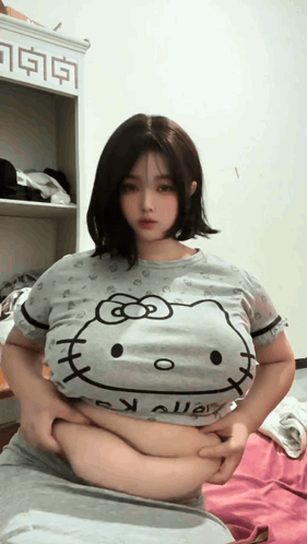 Woman in Hello Kitty T-Shirt Holding Belly