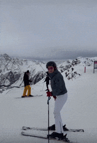 Woman in Helmet and Goggles Holding Ski Pole in Snow